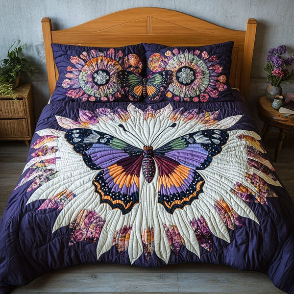 Winged Paradise quilted 3-piece bedding set on a made bed with two matching pillow shams