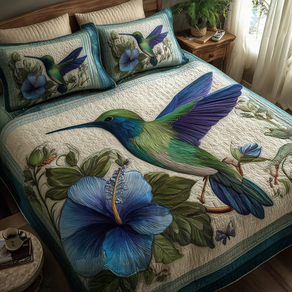 Wings & Blue Petals quilted 3-piece bedding set on a made bed with two matching pillow shams
