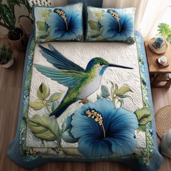 Wings & Blue Petals quilted 3-piece bedding set on a made bed with two matching pillow shams