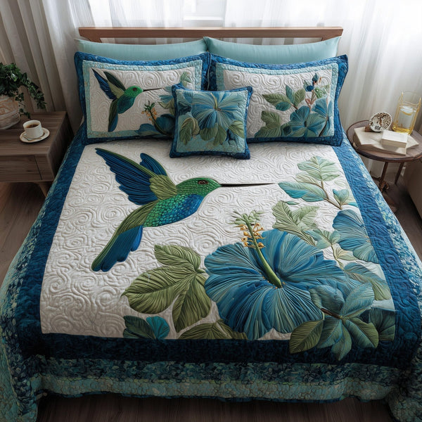 Wings & Blue Petals quilted 3-piece bedding set on a made bed with two matching pillow shams