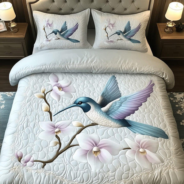 Wings of the Wild Bloom quilted 3-piece bedding set on a made bed with two matching pillow shams