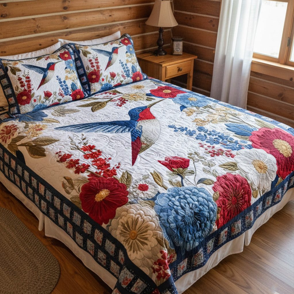 Wings Over Blooming Fields quilted 3-piece bedding set on a made bed with two matching pillow shams