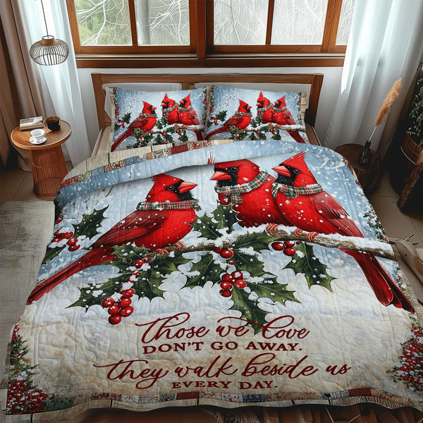 Winter Cardinals quilted 3-piece bedding set on a made bed in a winter-styled bedroom