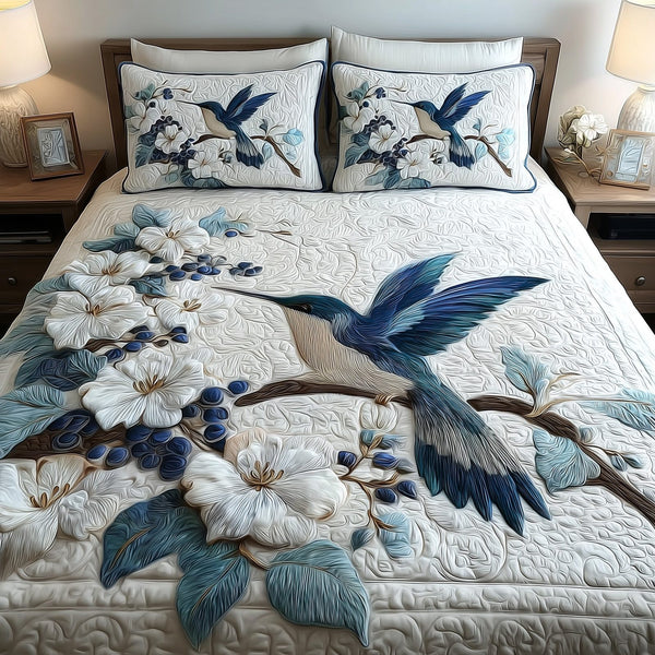 Winter Hummingbird Dancing quilted 3-piece bedding set on a made bed in a winter-styled bedroom