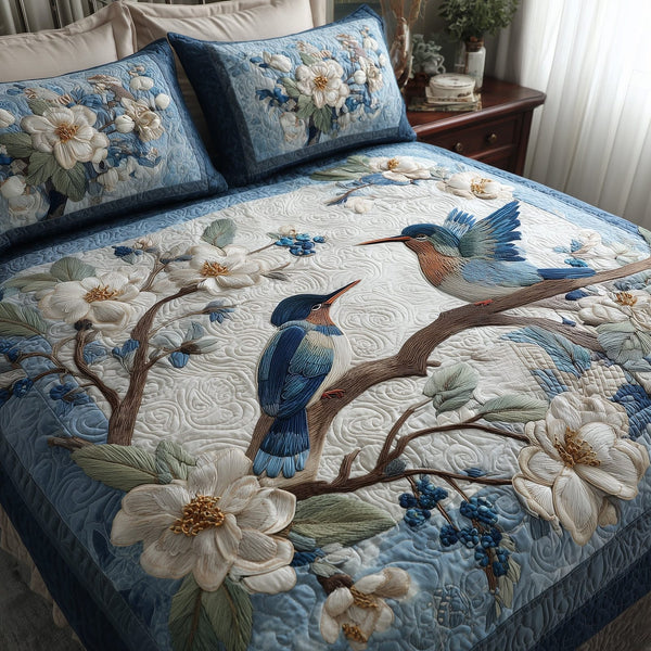 Winter Hummingbird Love quilted 3-piece bedding set on a made bed in a winter-styled bedroom