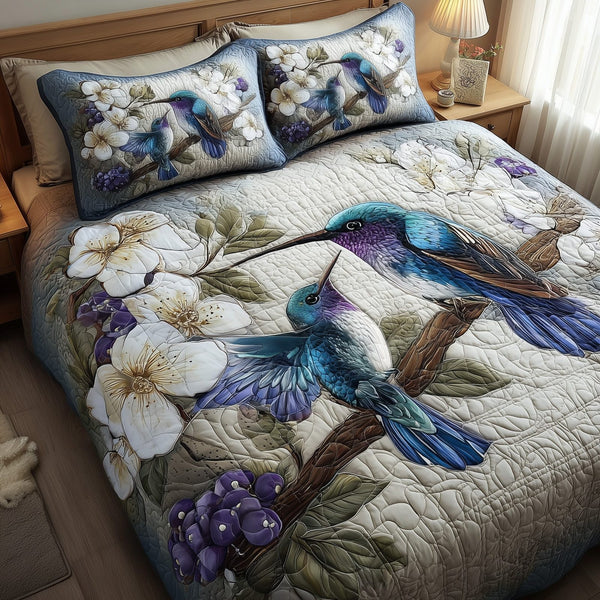 Winter Hummingbird Love quilted 3-piece bedding set on a made bed in a winter-styled bedroom