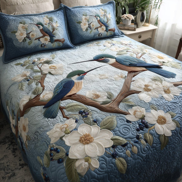 Winter Hummingbird Love quilted 3-piece bedding set on a made bed in a winter-styled bedroom