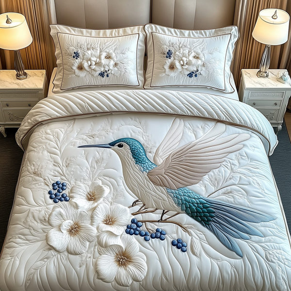 Winter Hummingbird quilted 3-piece bedding set on a made bed in a winter-styled bedroom