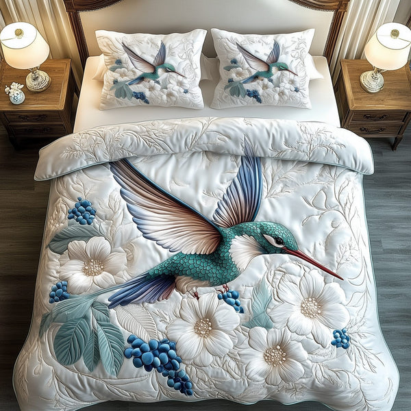Winter Hummingbird quilted 3-piece bedding set on a made bed in a winter-styled bedroom