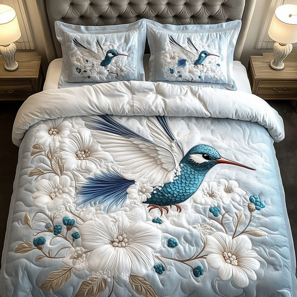 Winter Hummingbird quilted 3-piece bedding set on a made bed in a winter-styled bedroom